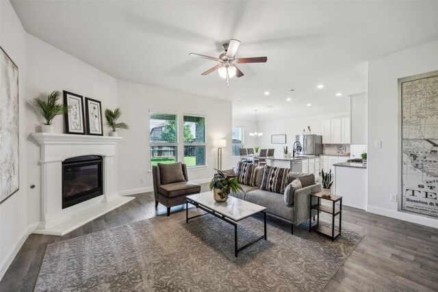 6217 Cheshire St, Celina, TX 76227 - living room with ceiling fan, a glass covered fireplace, dark wood finished floors, baseboards, and recessed lighting