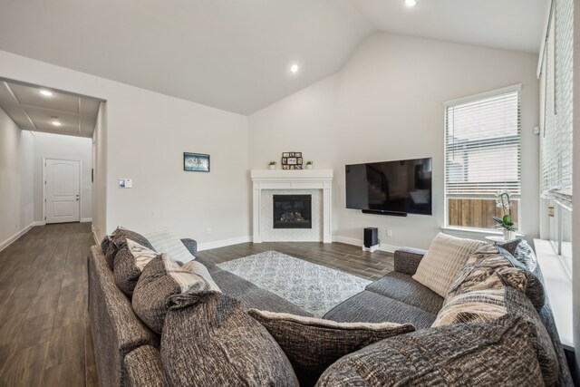 2811 Trinity Ridge St, Mansfield, TX 76063 - living room with vaulted ceiling, dark wood-type flooring, recessed lighting, a glass covered fireplace, and baseboards