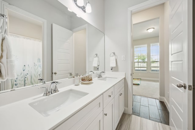 2811 Trinity Ridge St, Mansfield, TX 76063 - bathroom featuring double vanity, wood finished floors, and baseboards
