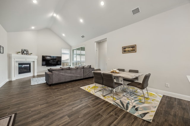 2811 Trinity Ridge St, Mansfield, TX 76063 - dining room with baseboards, wood finished floors, a glass covered fireplace, recessed lighting, and high vaulted ceiling