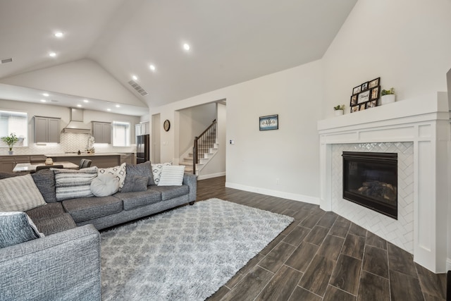 2811 Trinity Ridge St, Mansfield, TX 76063 - living room featuring stairway, a tile fireplace, dark wood finished floors, recessed lighting, and baseboards