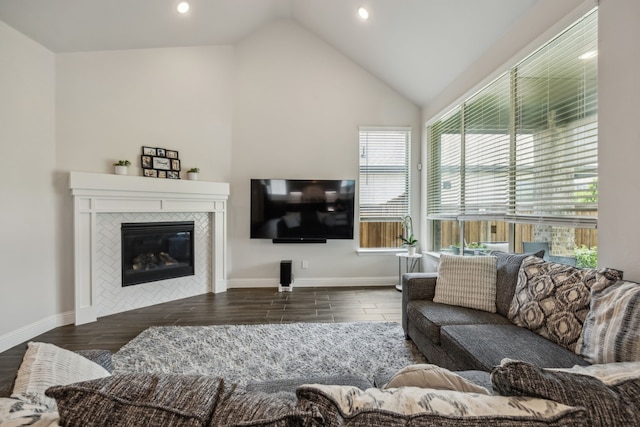 2811 Trinity Ridge St, Mansfield, TX 76063 - living room with healthy amount of natural light, recessed lighting, vaulted ceiling, a tiled fireplace, and wood finished floors