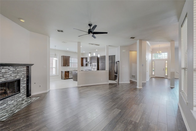 2728 Gull Lake Dr, Plano, TX 75025 - unfurnished living room featuring dark wood-style floors, plenty of natural light, a ceiling fan, a fireplace, and recessed lighting