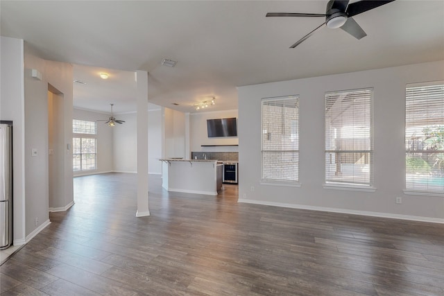 2728 Gull Lake Dr, Plano, TX 75025 - unfurnished living room with ceiling fan, dark wood finished floors, baseboards, and wine cooler