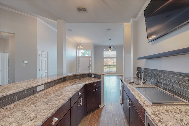 2728 Gull Lake Dr, Plano, TX 75025 - kitchen featuring a sink, wood-type flooring, crown molding, ceiling fan, and dark brown cabinetry