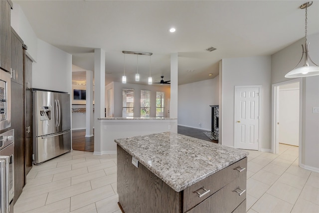 2728 Gull Lake Dr, Plano, TX 75025 - kitchen with stainless steel refrigerator with ice dispenser, light tile patterned floors, a kitchen island, a ceiling fan, and pendant lighting