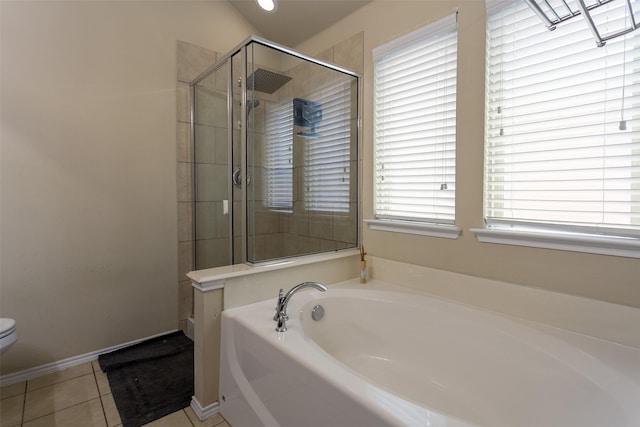 4633 Sleepy Meadows Dr, Fort Worth, TX 76244 - bathroom featuring a bath, a shower stall, toilet, tile patterned flooring, and baseboards