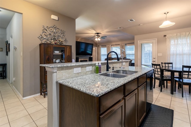 4633 Sleepy Meadows Dr, Fort Worth, TX 76244 - kitchen featuring a sink, light tile patterned floors, ceiling fan, and dark brown cabinetry