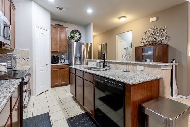 4633 Sleepy Meadows Dr, Fort Worth, TX 76244 - kitchen with stainless steel appliances, a sink, tasteful backsplash, a center island with sink, and light tile patterned floors