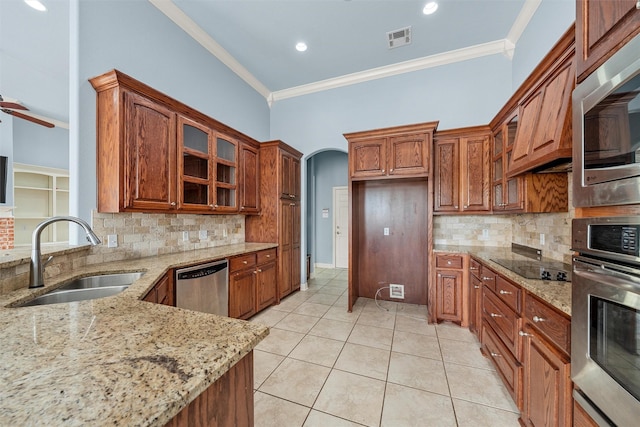 1405 Gunnison Dr, Waco, TX 76712 - kitchen featuring a sink, stainless steel appliances, ornamental molding, light stone countertops, and tasteful backsplash