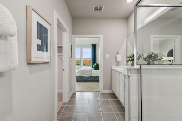 2101 Sandpiper Way, Princeton, TX 75407 - bathroom with vanity, connected bathroom, baseboards, and tile patterned flooring