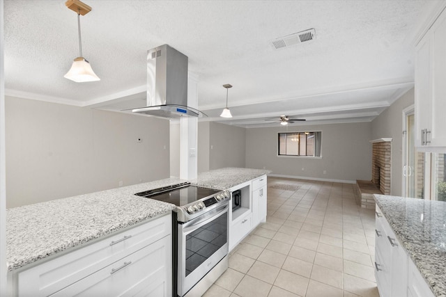 3416 Bristol Dr, Arlington, TX 76013 - kitchen with stainless steel electric range oven, island exhaust hood, light tile patterned floors, black microwave, and white cabinets