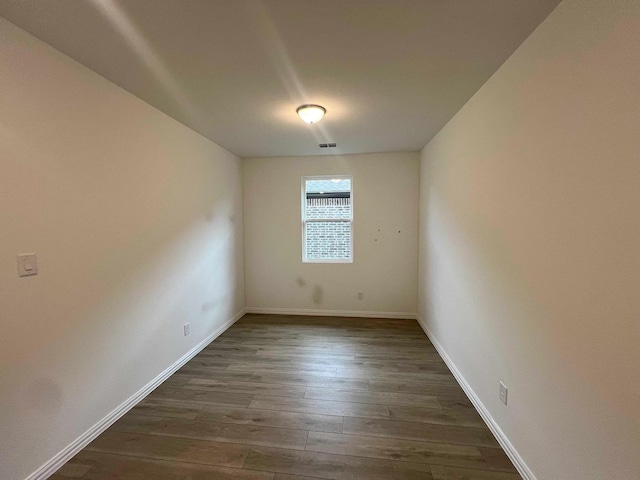 2121 Williams, Princeton, TX 75407 - unfurnished room with dark wood-style flooring and baseboards