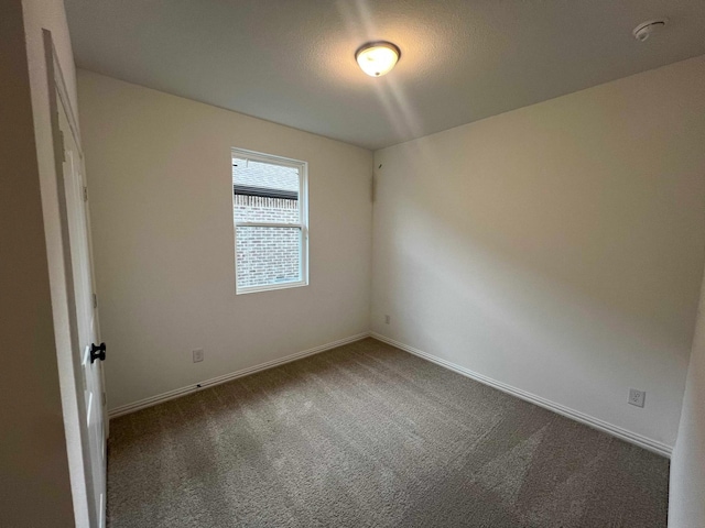 2121 Williams, Princeton, TX 75407 - empty room with dark colored carpet and baseboards