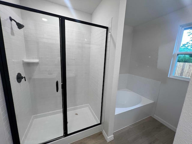 2121 Williams, Princeton, TX 75407 - full bathroom with a stall shower, a bath, wood finished floors, and baseboards