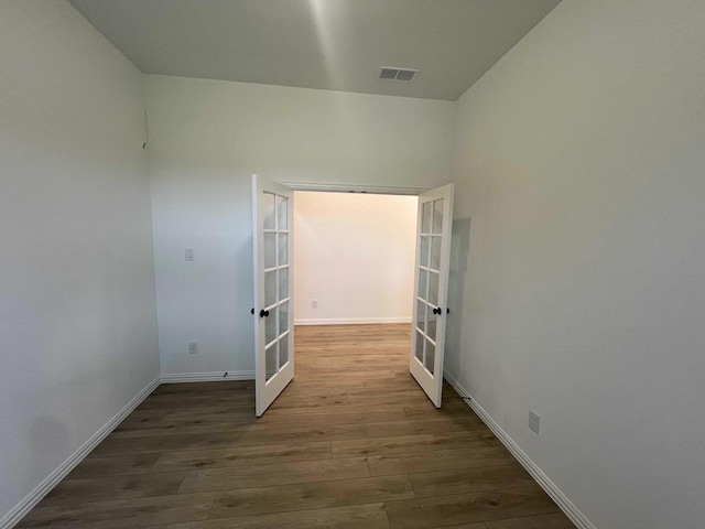 2121 Williams, Princeton, TX 75407 - empty room with french doors, wood finished floors, and baseboards