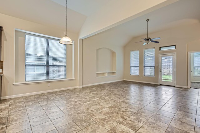 597 W Fate Main Pl, Fate, TX 75087 - kitchen featuring stainless steel appliances, arched walkways, tasteful backsplash, light stone countertops, and a kitchen island with sink