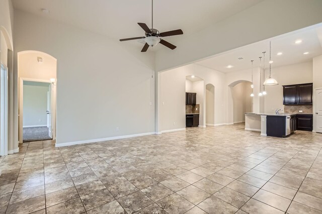 597 W Fate Main Pl, Fate, TX 75087 - kitchen with stainless steel appliances, dark brown cabinets, and tasteful backsplash