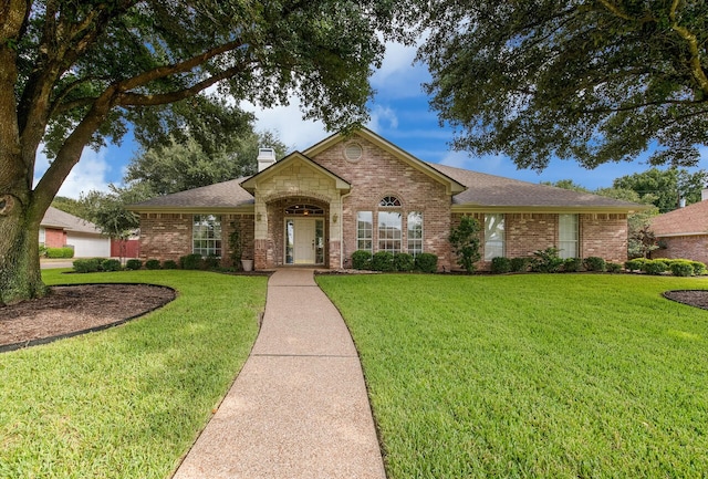1317 Radisson Dr, Hewitt, TX 76643 - view of front of house with brick siding, a chimney, a front yard, and a shingled roof