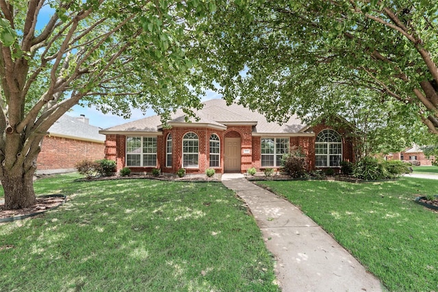 1707 Balboa Ln, Allen, TX 75002 - view of front facade featuring brick siding, a front yard, and roof with shingles