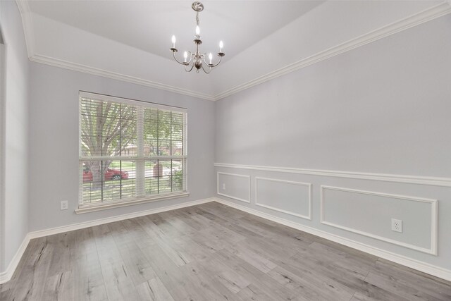 1707 Balboa Ln, Allen, TX 75002 - unfurnished room with a chandelier, wood finished floors, crown molding, and a wainscoted wall