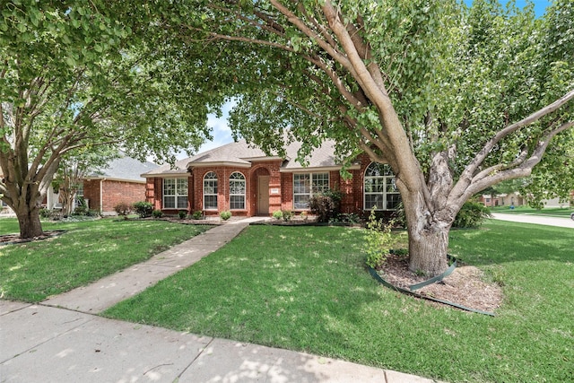 1707 Balboa Ln, Allen, TX 75002 - traditional home with brick siding, a front yard, and a shingled roof