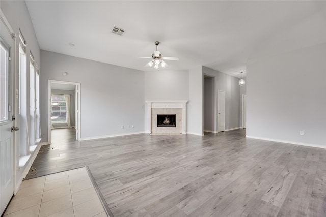 1707 Balboa Ln, Allen, TX 75002 - unfurnished living room featuring a ceiling fan, light wood-style floors, a fireplace, and baseboards
