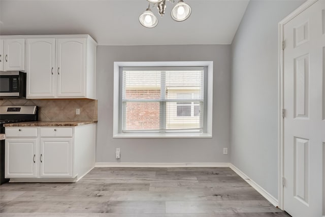 1707 Balboa Ln, Allen, TX 75002 - kitchen with appliances with stainless steel finishes, white cabinets, tasteful backsplash, and light wood-type flooring