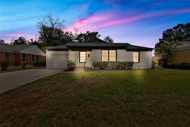 1516 Priscilla Ln, Irving, TX 75061 - view of front of house with a garage, concrete driveway, a front lawn, and brick siding