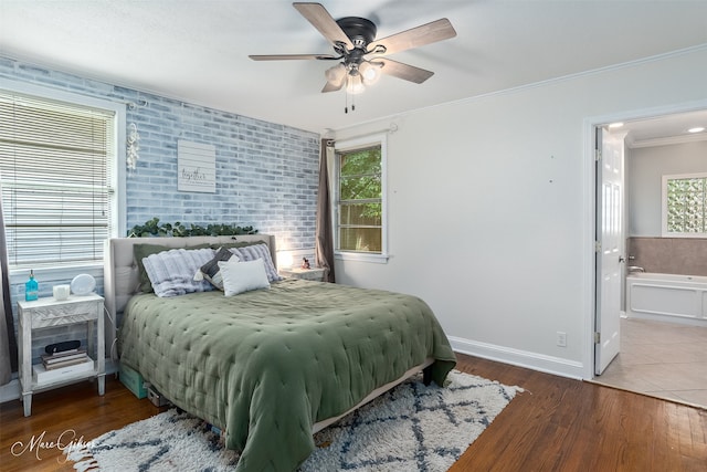 361 Carrollton Ave, Shreveport, LA 71105 - bedroom featuring multiple windows, ornamental molding, baseboards, wood finished floors, and ensuite bathroom