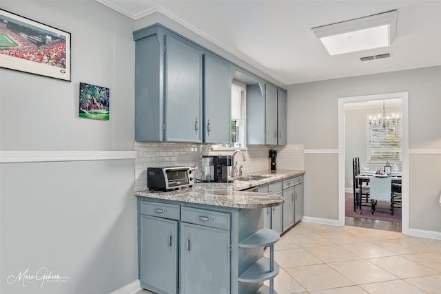361 Carrollton Ave, Shreveport, LA 71105 - kitchen featuring a sink, decorative backsplash, open shelves, a chandelier, and light tile patterned floors