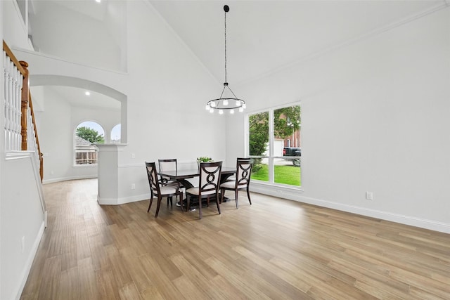 4309 Cutter Springs Ct, Plano, TX 75024 - dining room featuring stairs, plenty of natural light, arched walkways, light wood-type flooring, and high vaulted ceiling