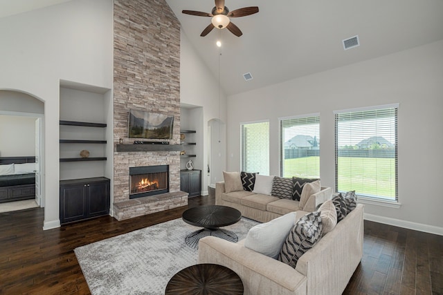 8220 Stonewall Dr, Waxahachie, TX 75167 - living area with a ceiling fan, dark wood finished floors, high vaulted ceiling, arched walkways, and a fireplace