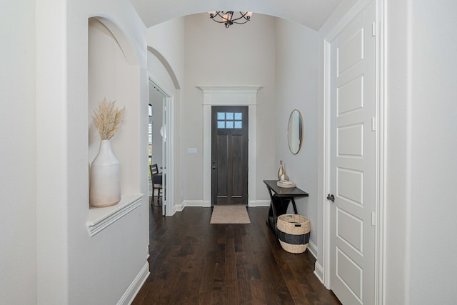 8220 Stonewall Dr, Waxahachie, TX 75167 - foyer with dark wood-style flooring, arched walkways, and baseboards