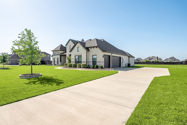 8220 Stonewall Dr, Waxahachie, TX 75167 - french country style house with stone siding, a garage, and concrete driveway