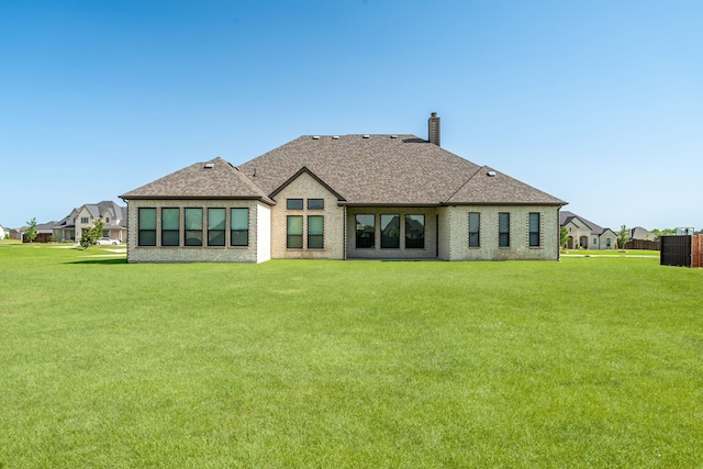 8220 Stonewall Dr, Waxahachie, TX 75167 - back of house with a lawn, a chimney, roof with shingles, and central air condition unit
