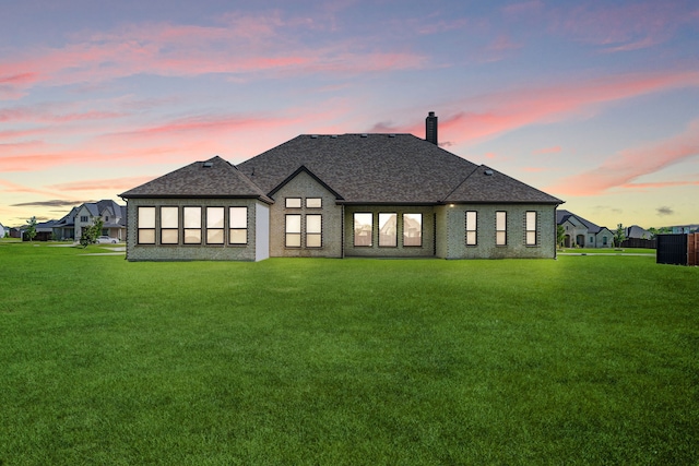 8220 Stonewall Dr, Waxahachie, TX 75167 - rear view of house featuring a chimney, a lawn, roof with shingles, and cooling unit