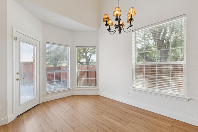 1084 Leisure Ln, Irving, TX 75063 - unfurnished dining area featuring a chandelier and wood finished floors