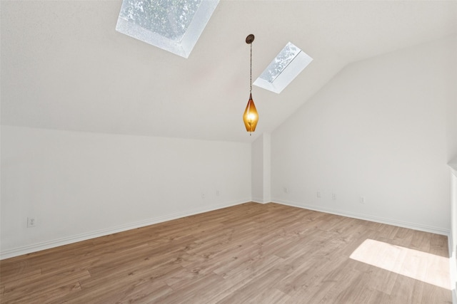 1084 Leisure Ln, Irving, TX 75063 - additional living space with a skylight, lofted ceiling, and light wood-style flooring
