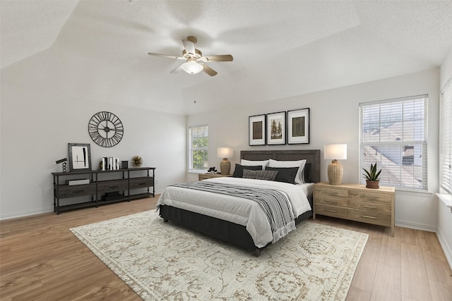 1084 Leisure Ln, Irving, TX 75063 - bedroom featuring vaulted ceiling, light wood-style flooring, and a ceiling fan