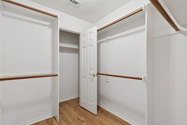 1084 Leisure Ln, Irving, TX 75063 - spacious closet with wood finished floors
