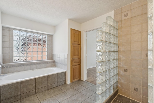 1084 Leisure Ln, Irving, TX 75063 - full bath featuring a garden tub, tile patterned flooring, and a textured ceiling