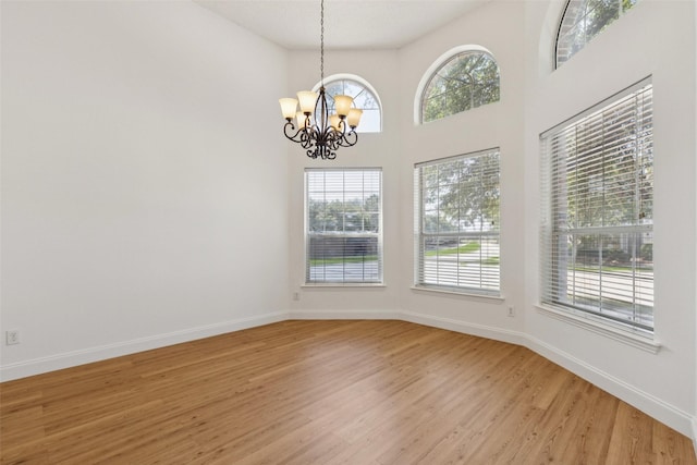 1084 Leisure Ln, Irving, TX 75063 - unfurnished room featuring a chandelier and light wood-type flooring
