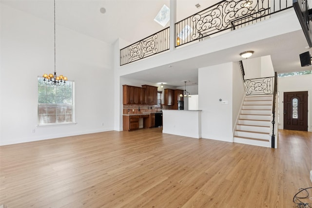 1084 Leisure Ln, Irving, TX 75063 - unfurnished living room with a high ceiling, light wood-type flooring, stairs, and plenty of natural light
