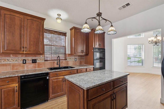 1084 Leisure Ln, Irving, TX 75063 - kitchen featuring black appliances, decorative backsplash, light wood-style flooring, light stone counters, and a textured ceiling
