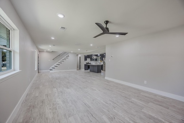 703 E Center St E, Duncanville, TX 75116 - unfurnished living room featuring stairs, a ceiling fan, recessed lighting, light wood-style flooring, and baseboards