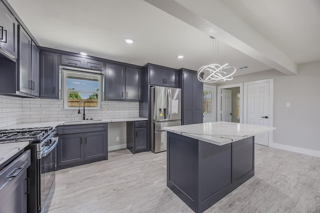 703 E Center St E, Duncanville, TX 75116 - kitchen with stainless steel appliances, a sink, decorative backsplash, a chandelier, and light stone counters