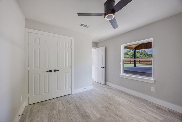 703 E Center St E, Duncanville, TX 75116 - unfurnished bedroom with a closet, wood finished floors, baseboards, and ceiling fan