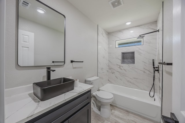 703 E Center St E, Duncanville, TX 75116 - bathroom featuring toilet, vanity, shower / washtub combination, and wood finished floors