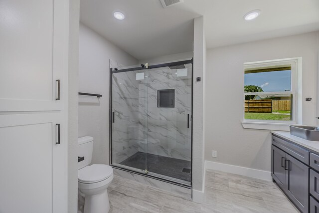 703 E Center St E, Duncanville, TX 75116 - full bathroom with toilet, a marble finish shower, vanity, baseboards, and recessed lighting